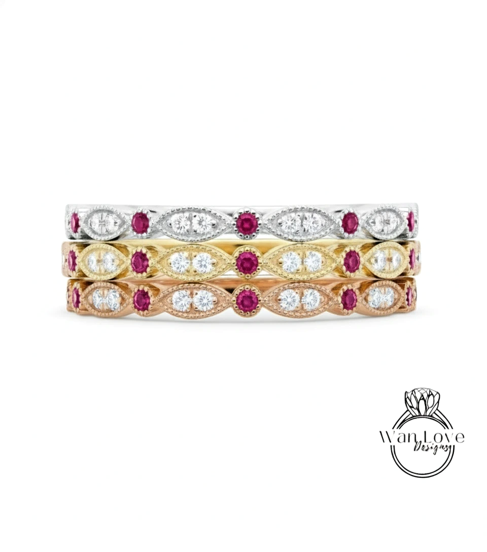 A stack of three rings with various gemstones, including diamonds and rubies.