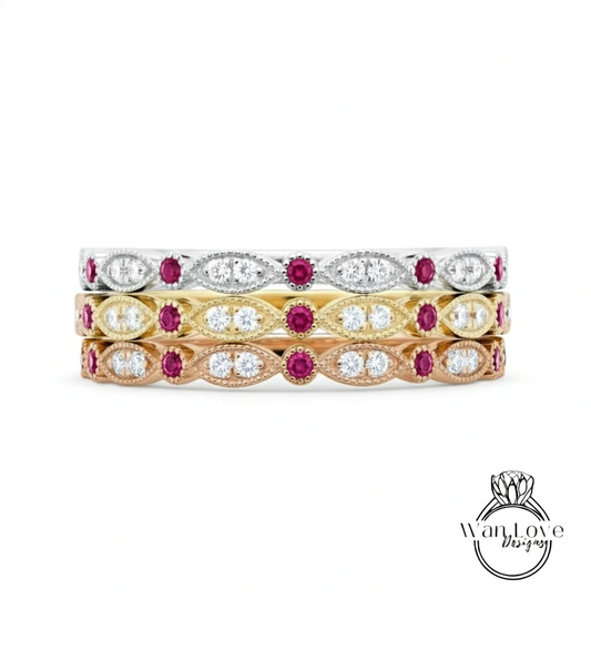 A stack of three rings with various gemstones, including diamonds and rubies.