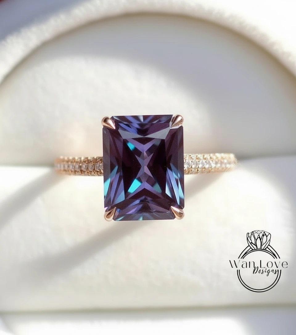 A close-up image of a gold ring with a large, rectangular purple gemstone set in the center.