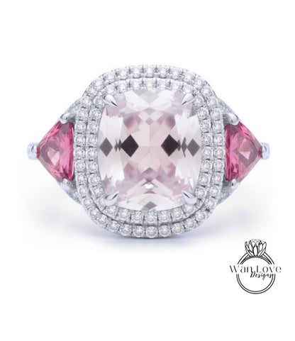 A large, pink gemstone ring with a halo of diamonds around it, set in a silver band.