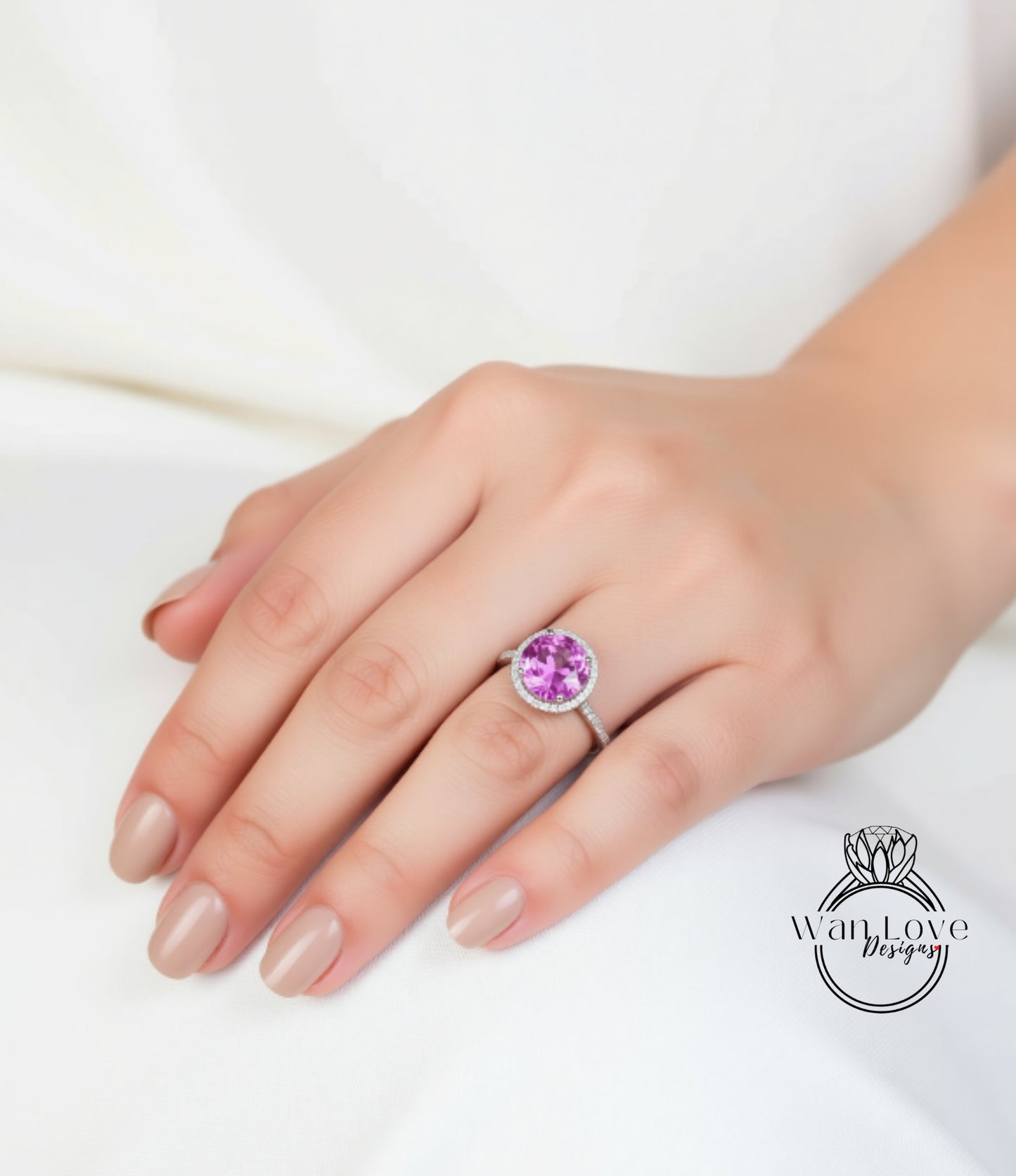 A close-up of a hand wearing a ring with a large, round, purple gemstone.