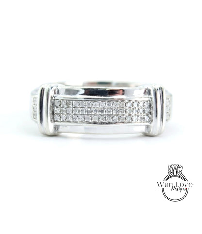 A silver ring with a row of small diamonds set in the band.