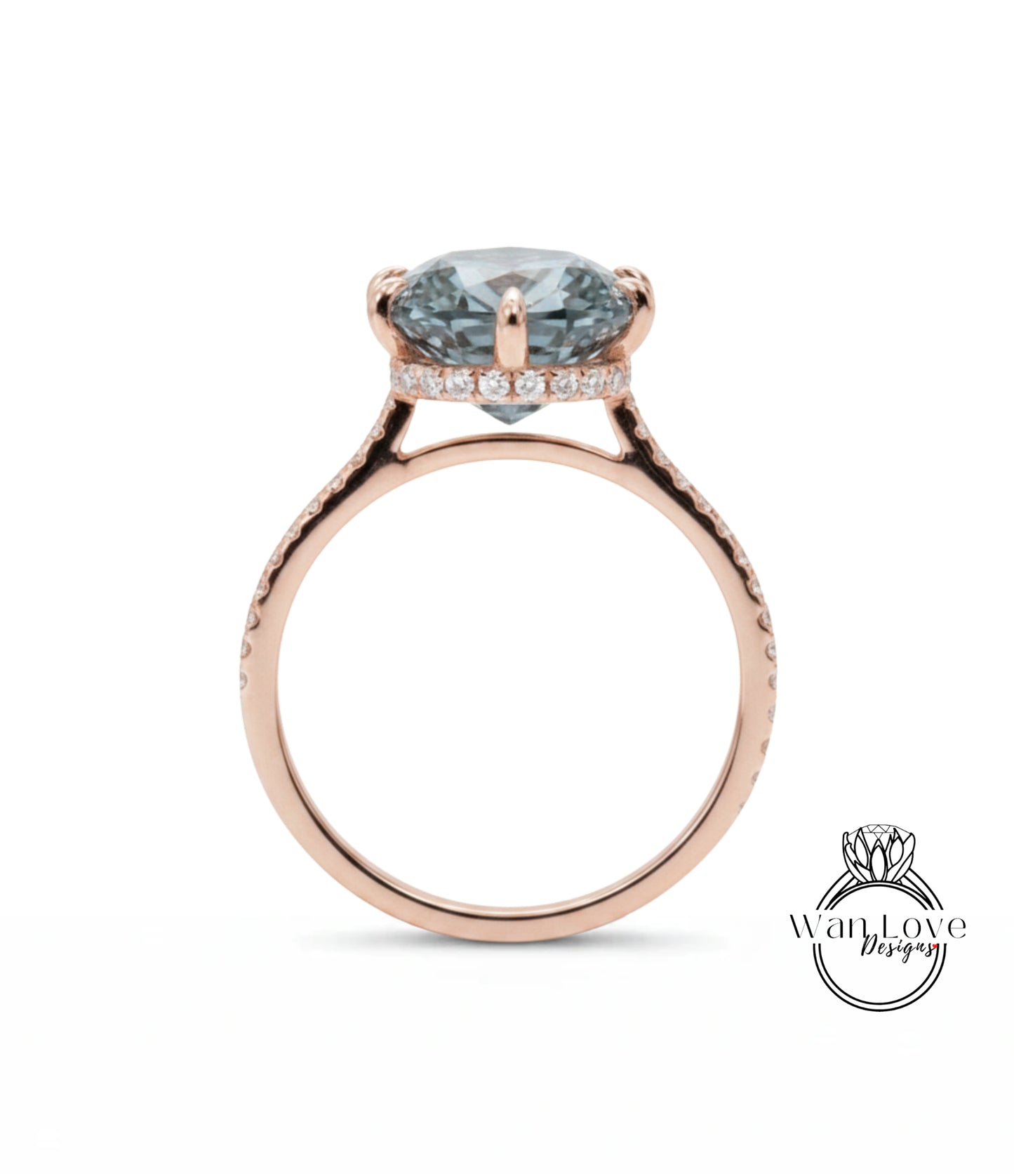 A rose gold engagement ring with a large blue gemstone set in the center, surrounded by smaller diamonds.