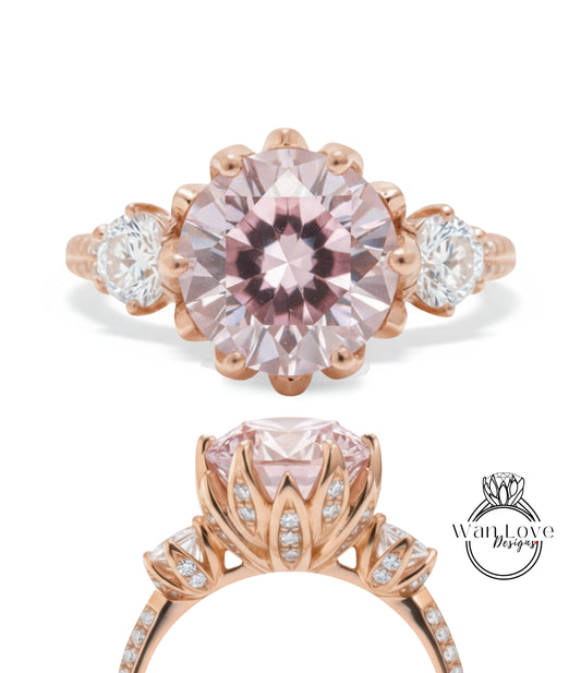 a beautiful pink gemstone engagement ring with a large central gemstone surrounded by smaller gemstones and a delicate floral design.