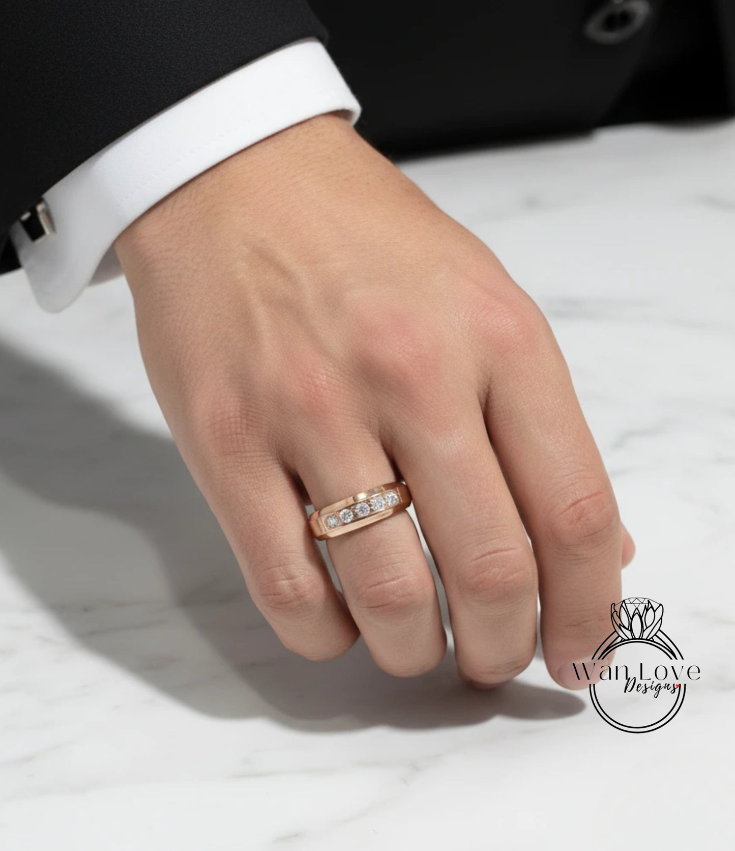 A close-up of a person's hand wearing a gold ring with a diamond.