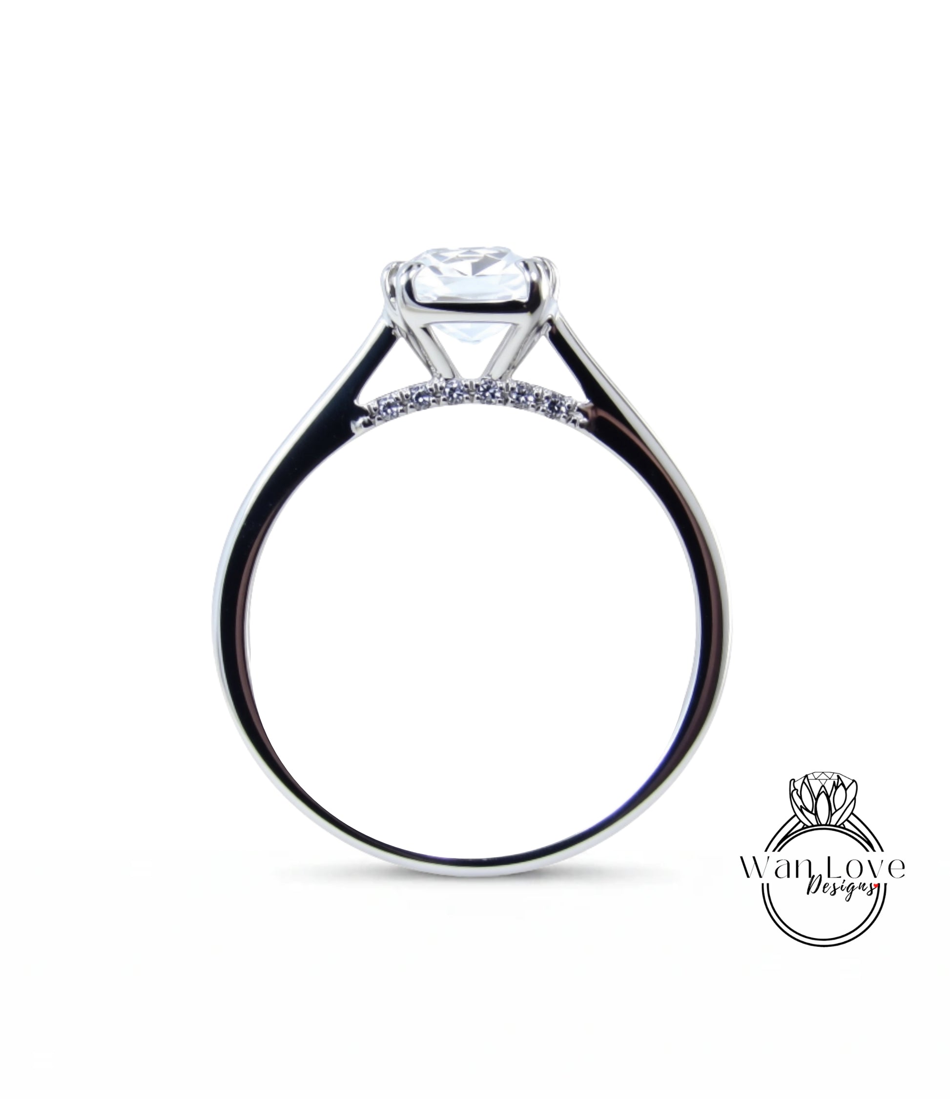 A close-up view of a silver engagement ring with a large central diamond and a smaller diamond band.