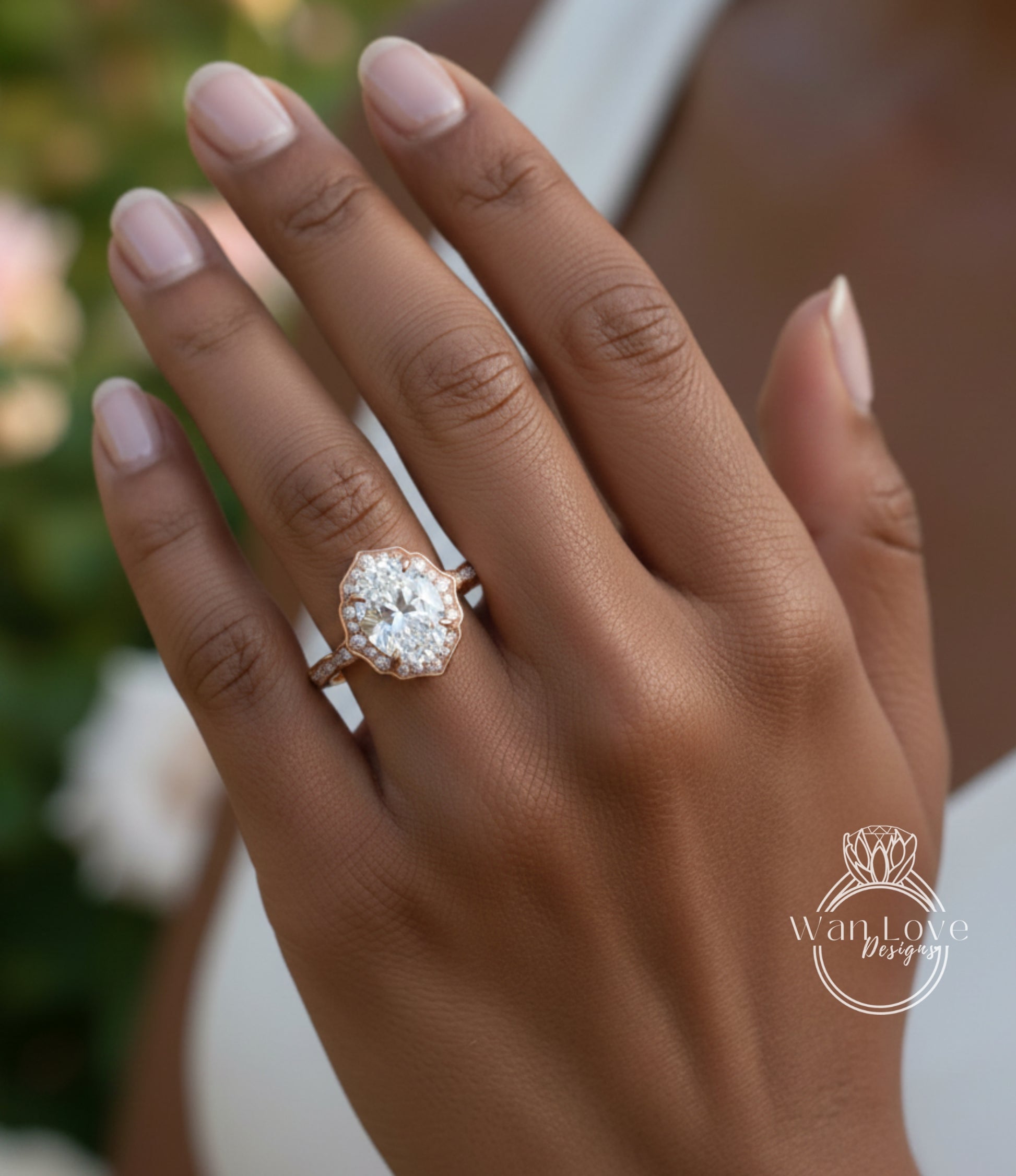 A close-up of a person's hand wearing a large, ornate diamond engagement ring.
