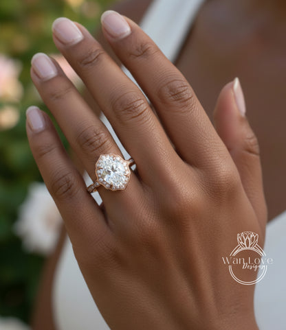 A close-up of a person's hand wearing a large, ornate diamond engagement ring.