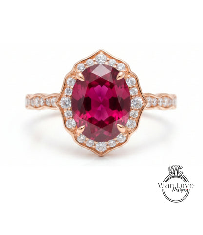A beautiful pink gemstone ring with a large oval-shaped gemstone at the center, surrounded by a halo of smaller diamonds.