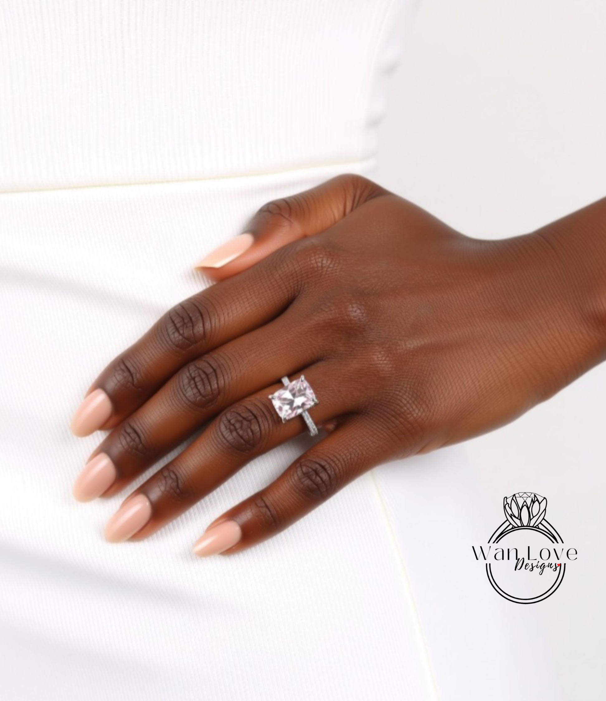 A close-up of a hand wearing a large diamond engagement ring.