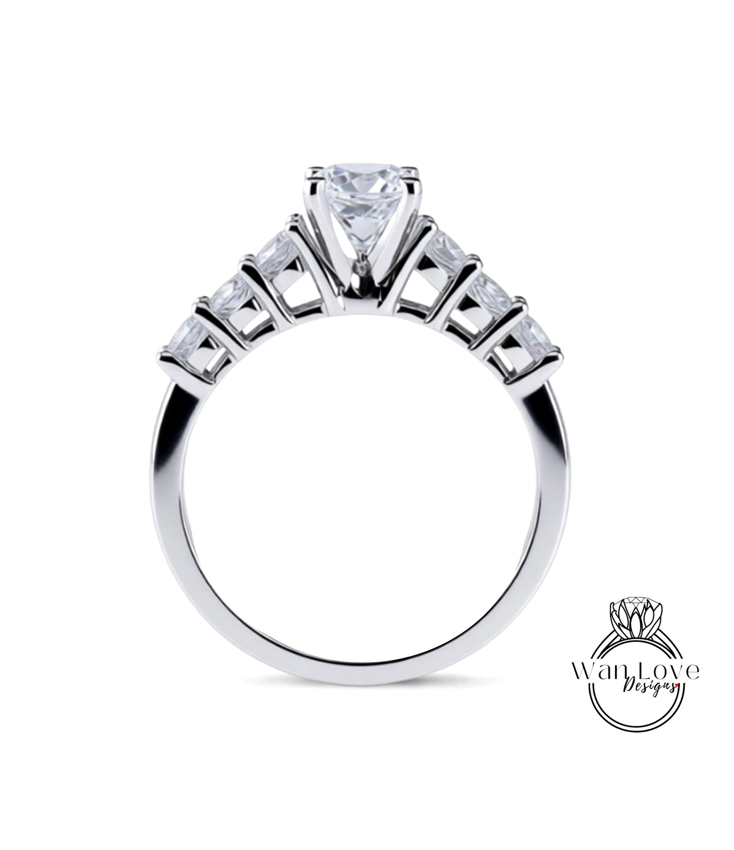 A close-up view of a silver engagement ring with a large central diamond surrounded by smaller diamonds arranged in a fan-like design on the band.