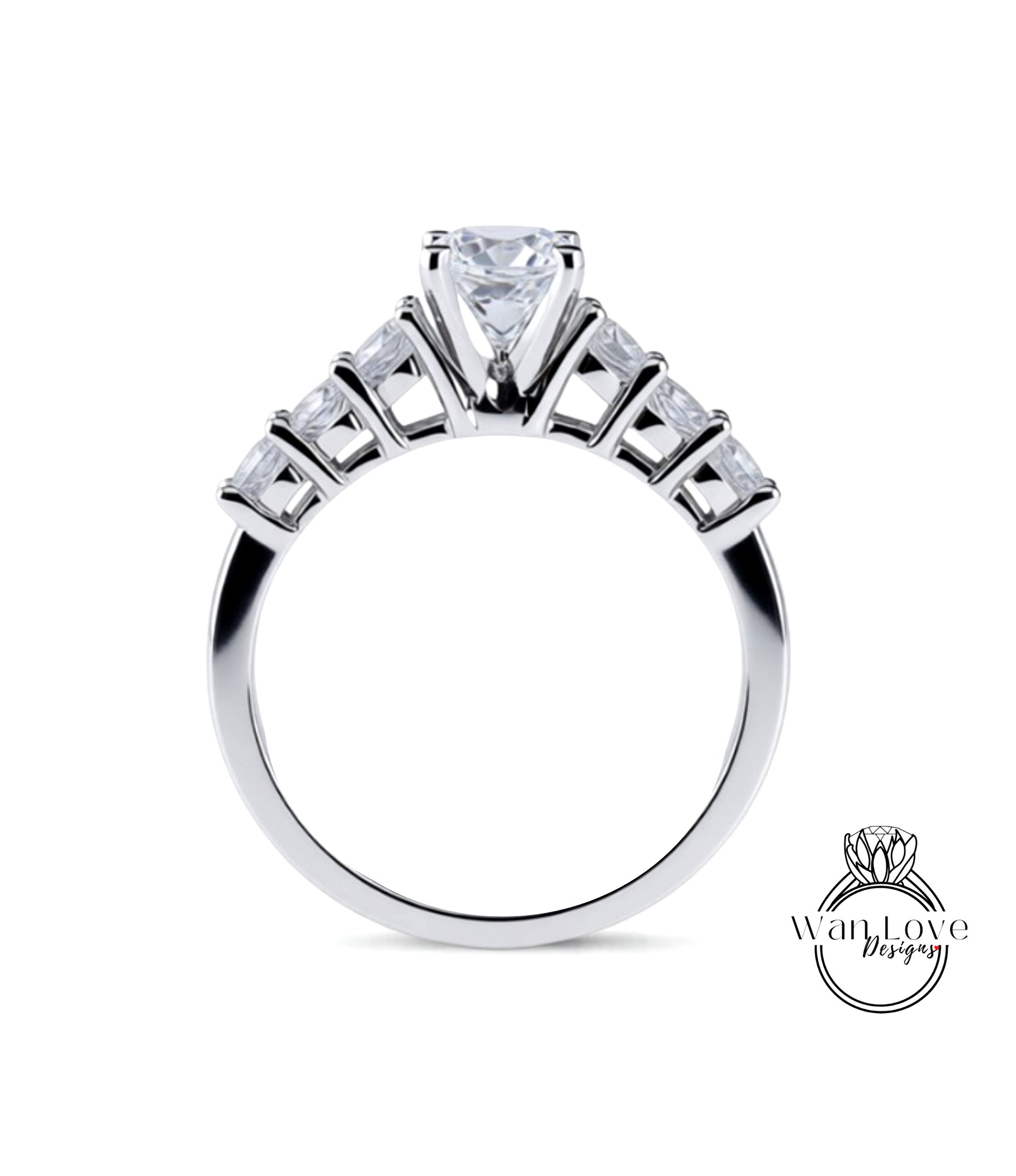A close-up view of a silver engagement ring with a large central diamond surrounded by smaller diamonds arranged in a fan-like design on the band.